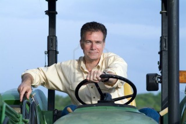 big pics mature mature photo male white sitting green handsome smiling tractor comfortably contentedly confid
