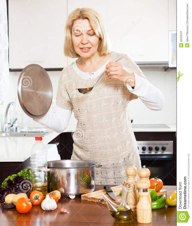 mature housewives photos mature home housewife kitchen happy housewives soup pan cooking interior ladle