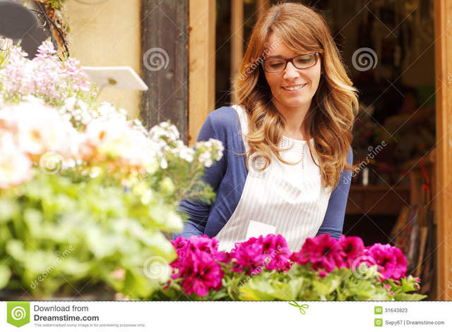 mature photos mature free woman small using business store take shop stock orders smiling flower royalty owner laptop shallow focus telephone florist
