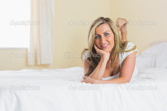 blonde mature woman photo looking bed camera depositphotos lying stock joyful