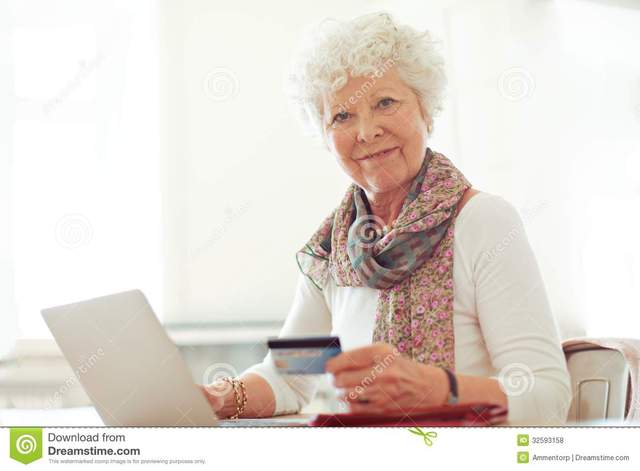 lady mature lady mature photos free online card credit stock front shopping smiling royalty holding laptop