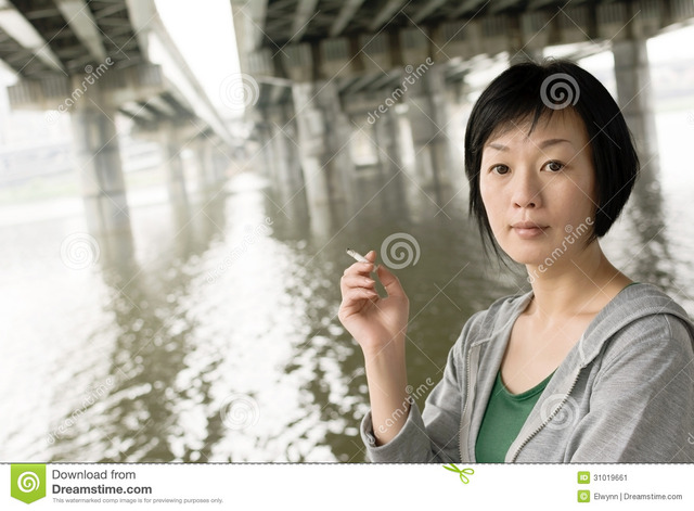 mature asian mature nude woman asian under smoking city portrait closeup daytime bridge