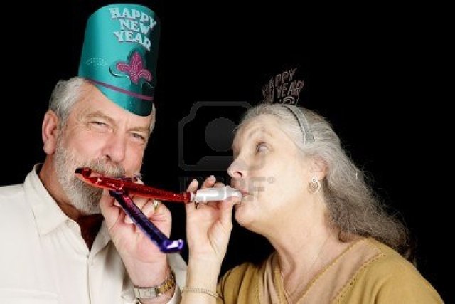 mature party mature couple black party photo year isolated hats lisafx blowing noise makers