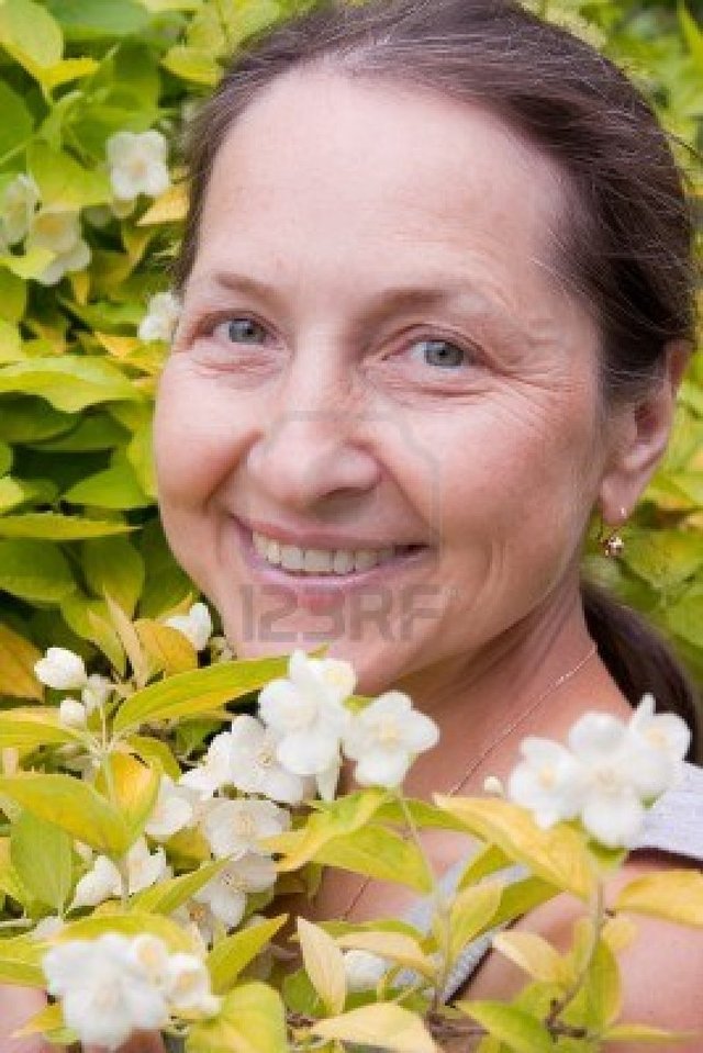 outdoor mature mature woman bush photo outdoor near jasmine blossoming