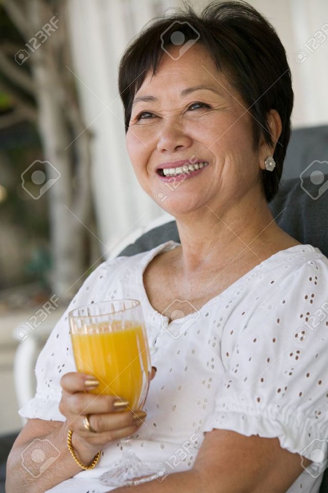 pictures of mature women mature woman women photo asian orange stock drinking juice moodboard