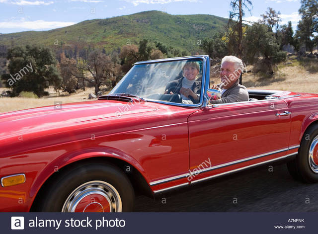 red mature mature couple photo red car road stock driving smiling country convertible comp along npnk