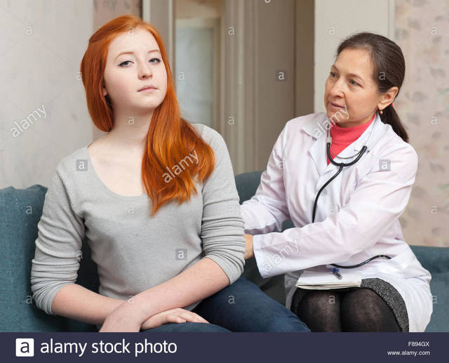 teen and mature mature teen girl photo behind stock patient comp focus physician palpates
