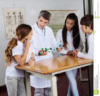 mature porn teacher teacher explaining molecular structures mature male students desk science lab student using computer classroom