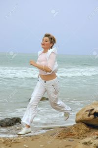 images mature women pooh beautiful mature women running beach sea stock photo