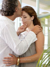 mature close up depositphotos close mature couple kissing home standing large glass doors stock photo