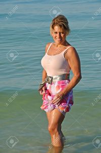 mature photos eyemark attractive mature woman wading ocean stock photo beautiful