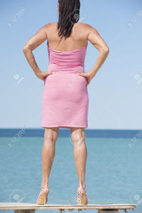 mature sexy roboriginal portrait beautiful mature woman standing leisure sexy pose table ocean wearing red summer stock photo