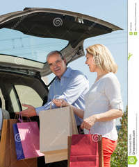 mature wife picture mature husband wife putting car shopping bags happy trunk stock photo