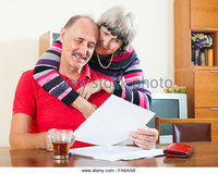 mature wife pix zooms cheeful mature man wife reading financial documents table aar stock photo write