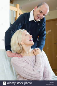 mature wife pix comp faf portrait senior smiling man giving tired mature wife back massage stock photo