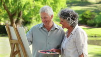 mature wife pix shutterstock videos video clip stock footage smiling mature man looking his wife who painting countryside