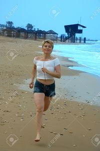 mature women photo pooh beautiful mature women running beach sea stock photo