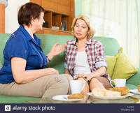 mature women pictures comp sad mature women talking couch home stock photo