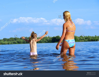mom bikini stock photo beautiful mom bikini looks daughter who wants start swimming shot june near pic