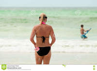 mom bikini mom bikini swimsuit behind beach female mother stock photo