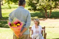 wife mature pic mature man offering flowers his wife photo