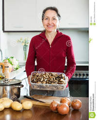 you porn mature mature housewife holding dried mushrooms portrait happy