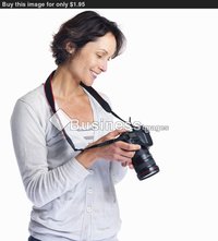 beautiful mature beautiful mature woman holding camera isolated white background buy stock photo female photographer checking here digital slr came