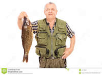 big mature smiling mature fisherman holding fish white background stock photo