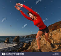 big mature comp bycych fit mature woman exercises outdoors along sur coastline pacific stock photo