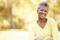 black mature stockbroker mature woman relaxing autumn landscape stock photo smiling black