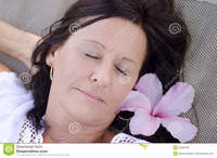 facial mature portrait beautiful mature woman sleeping smiling happy relaxed facial expression closed eyes flower hair