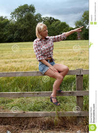 lady mature mature lady sitting fence pointing left royalty free stock photography