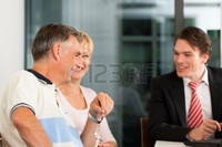 mature and young kzenon mature couple young financial consultant they are planning their retirement photo