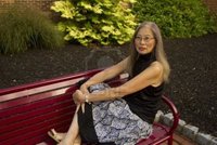 mature feet fmcginn mature senior asian woman seated red metal bench feet take break photo