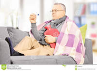 mature hot sick man sofa hot water bottle looking thermomete mature thermometer home stock photography