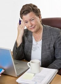 mature hot forestpath mature businesswoman desk having hot flash headache looking camera very distressed photo