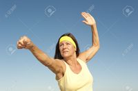 mature spread roboriginal portrait attractive fit healthy mature woman relaxed exercising outdoor arms spread out bal stock photo