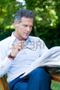 outdoor mature rido handsome mature man reading news outdoor break holding pair glasses photo