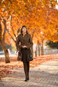 outdoor mature tankist happiness mature beautiful woman walking outdoor park autumnal day photo