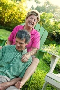 outdoor mature forestpath lifestyle shot happy mature couple relaxing sun drenched outdoor setting photo