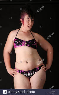 pierced mature comp exp plump alternative model bikini shot black complete stock photo piercings tattoo