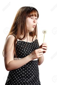 teen and mature lanadesign teen girl blowing mature dandelion isolated white stock photo