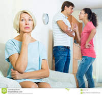 wife mature mature woman watching young family couple quarrel home husband wife quarrelling indoors senior mother taking hard stock photo