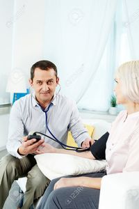 wife mature pressmaster portrait mature man measuring blood pressure his wife looking camera stock photo