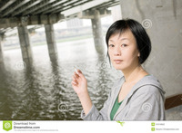 asian mature pics woman smoking closeup portrait mature asian under bridge city daytime stock photography