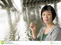 mature asian woman smoking closeup portrait mature asian under bridge city daytime nude