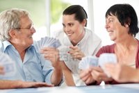 mature old logos smiling mature woman old people playing cards home indoor photo