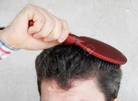 red mature simply mature man brushing black greyish hair red hairbrush photo