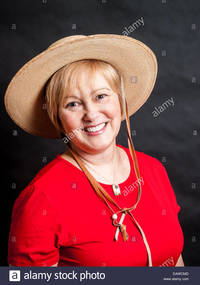 red mature comp eawcmd happy mature woman wearing red shirt cowgirl hat stock photo